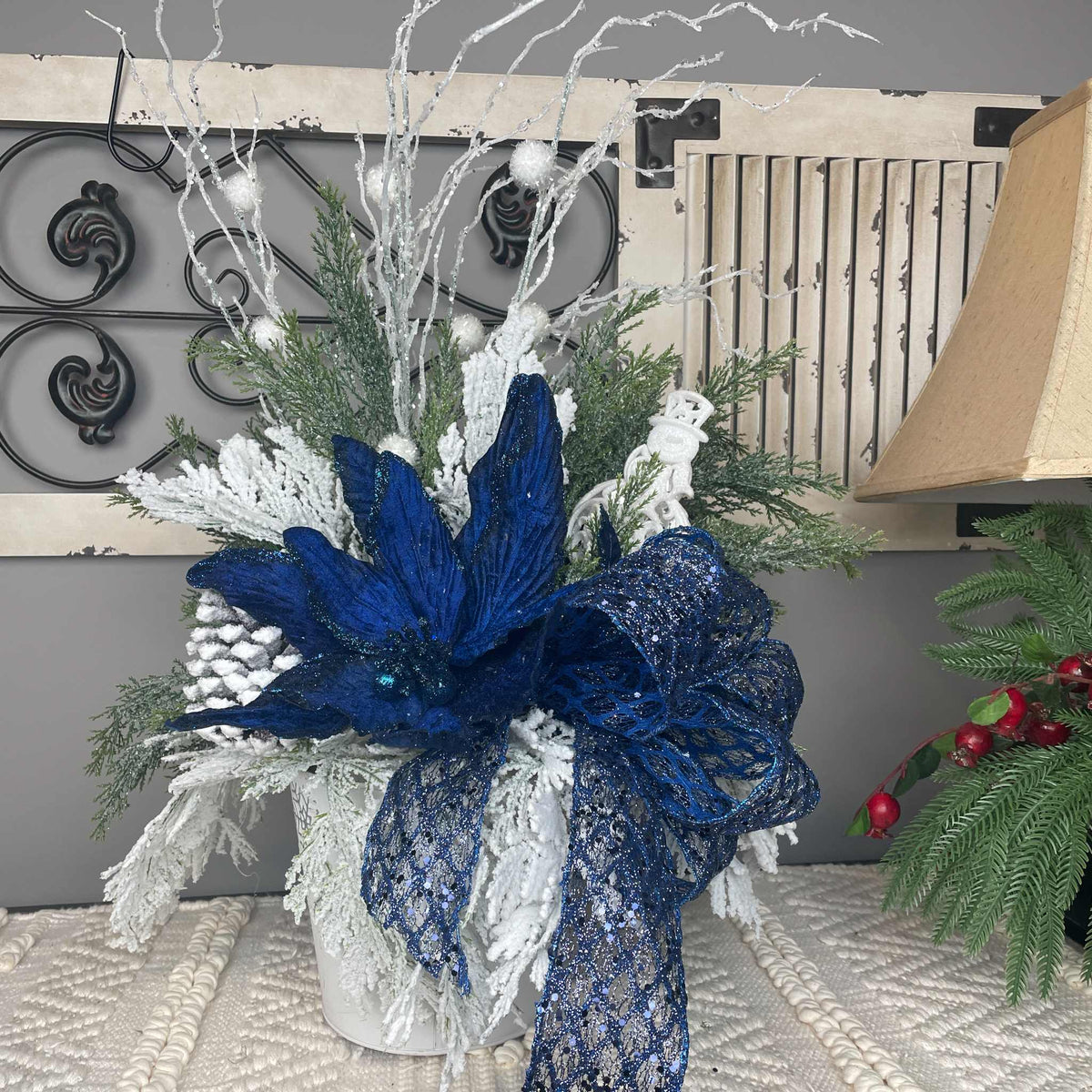 Winter Blue Poinsettia Centerpiece with Snowy Cedar & Snowflake Pail