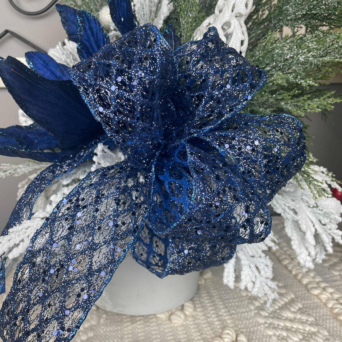 Winter Blue Poinsettia Centerpiece with Snowy Cedar & Snowflake Pail