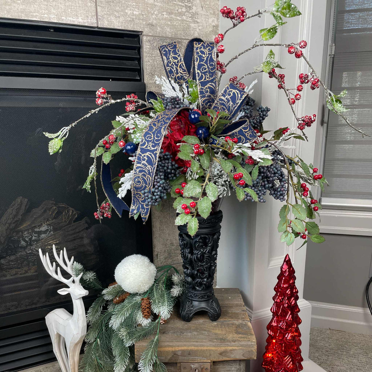 Christmas Floral Centerpiece with Iced Berries & Navy Blue Bow in Cast Iron Vase