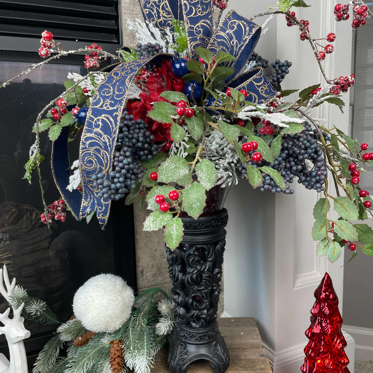 Christmas Floral Centerpiece with Iced Berries & Navy Blue Bow in Cast Iron Vase