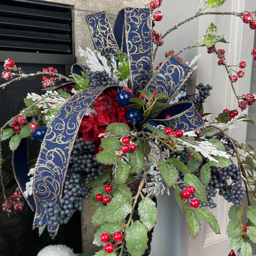 Christmas Floral Centerpiece with Iced Berries & Navy Blue Bow in Cast Iron Vase