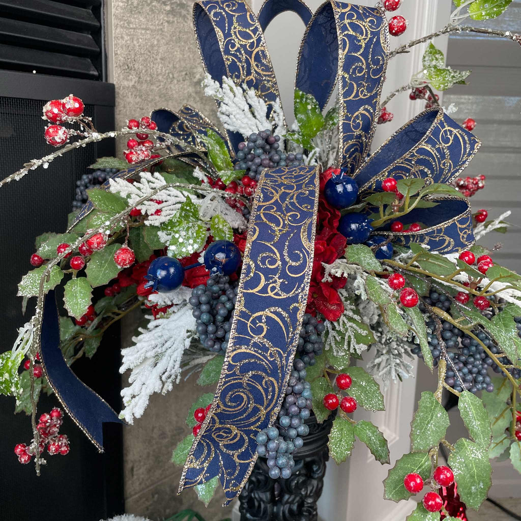 Christmas Floral Centerpiece with Iced Berries & Navy Blue Bow in Cast Iron Vase