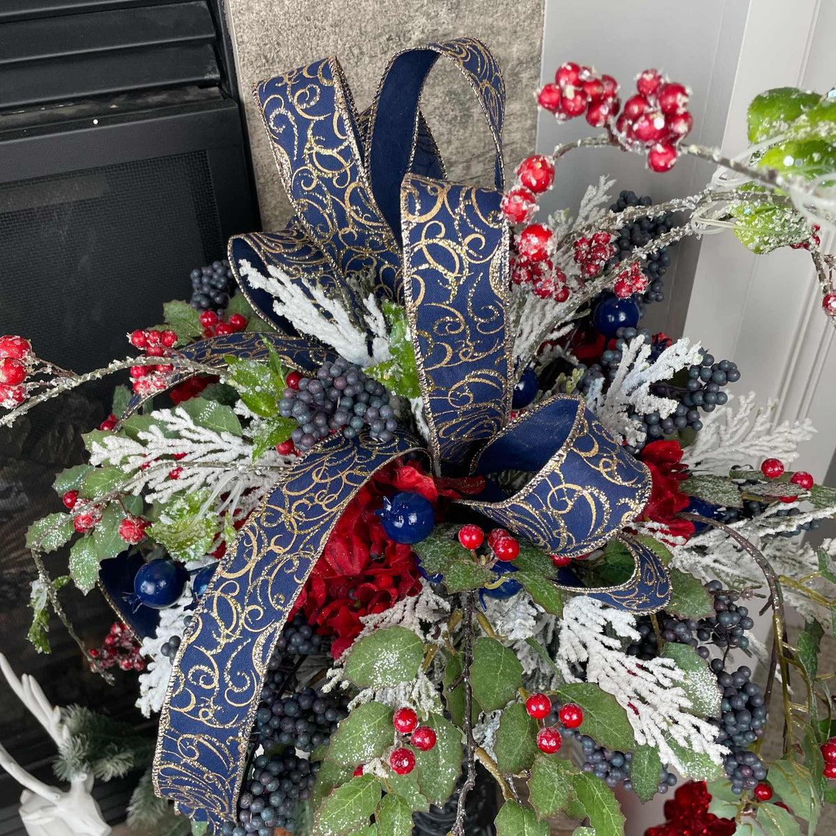Christmas Floral Centerpiece with Iced Berries & Navy Blue Bow in Cast Iron Vase