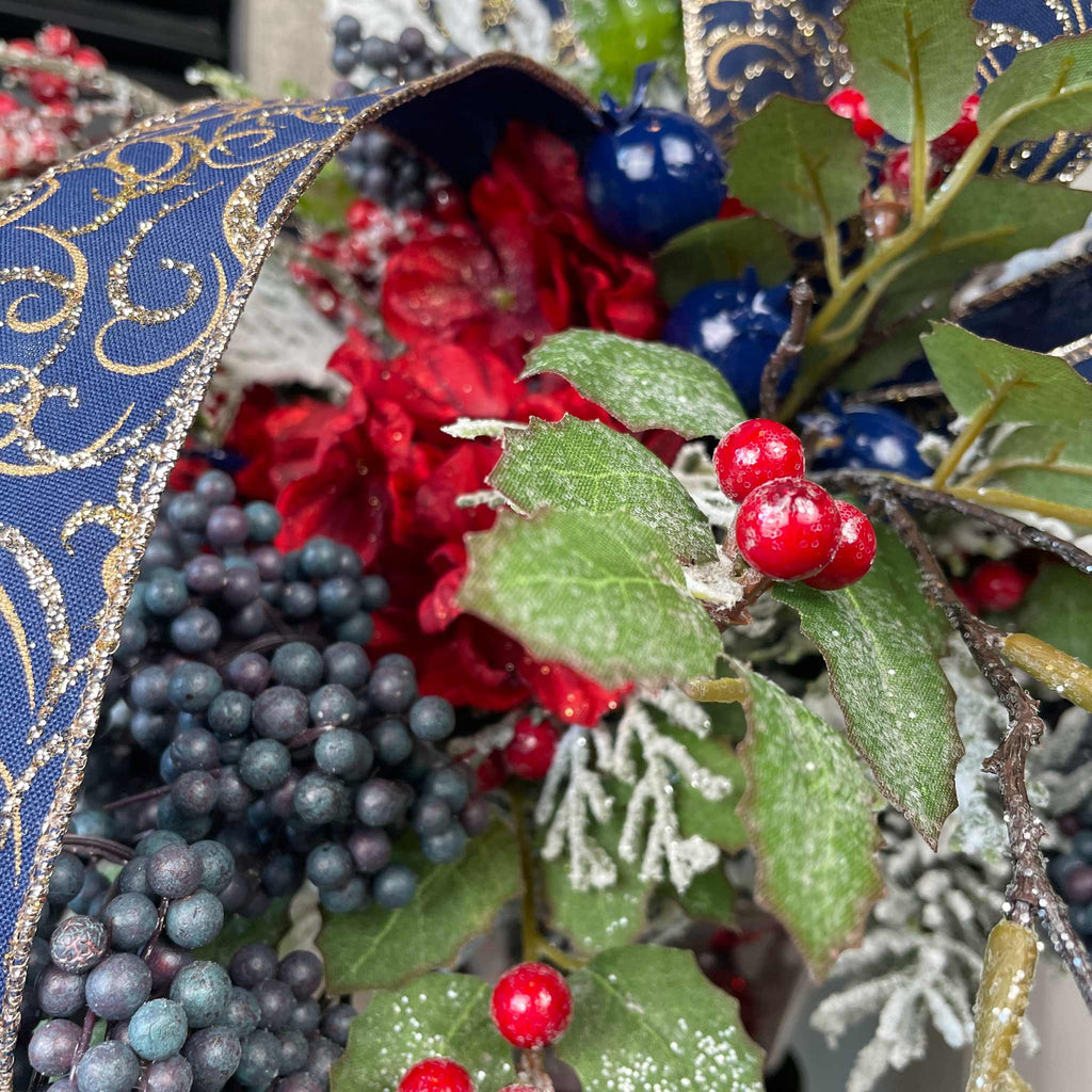 Christmas Floral Centerpiece with Iced Berries & Navy Blue Bow in Cast Iron Vase