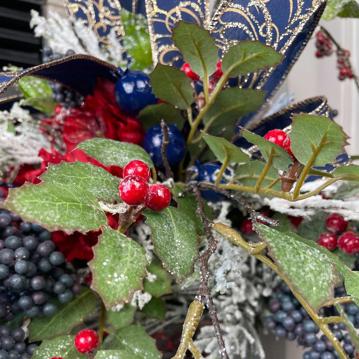 Christmas Floral Centerpiece with Iced Berries & Navy Blue Bow in Cast Iron Vase