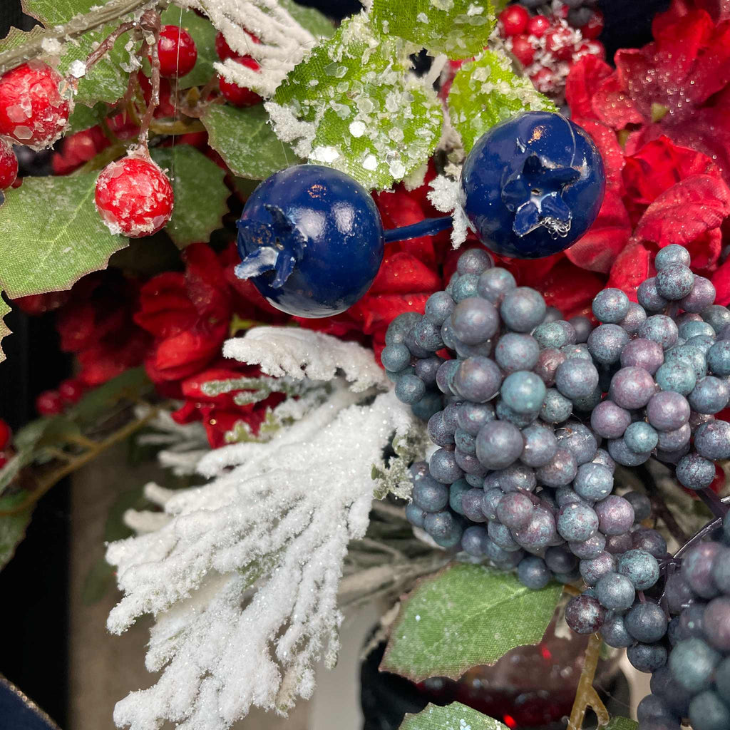 Christmas Floral Centerpiece with Iced Berries & Navy Blue Bow in Cast Iron Vase