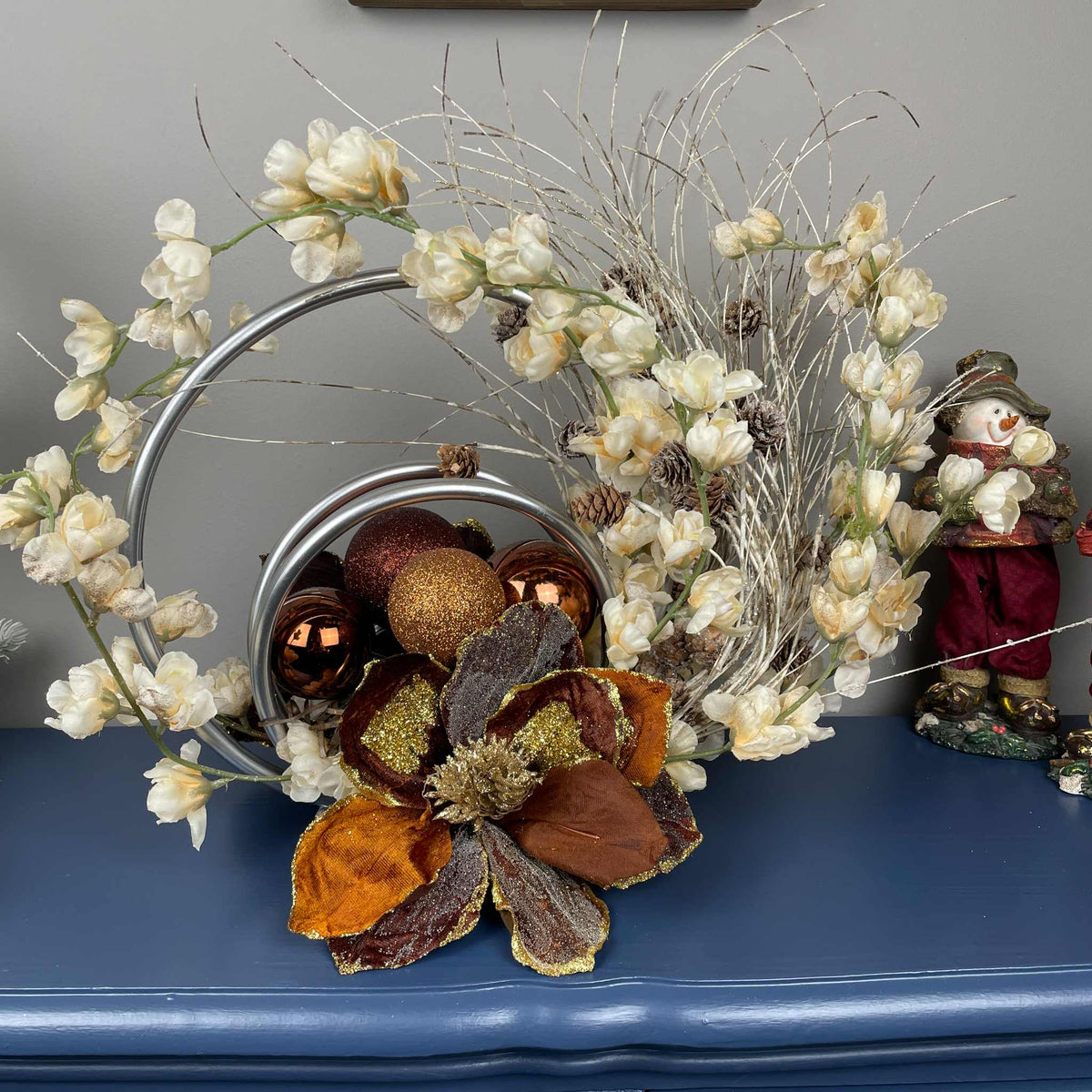 Bronze Magnolia Centerpiece with Cream Flowers & Silver Rings