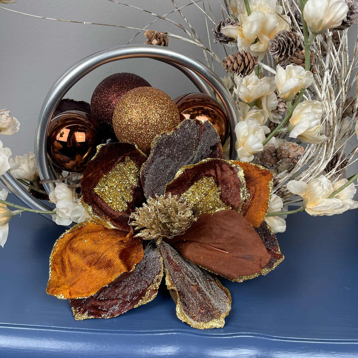 Bronze Magnolia Centerpiece with Cream Flowers & Silver Rings