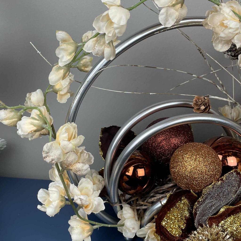 Bronze Magnolia Centerpiece with Cream Flowers & Silver Rings