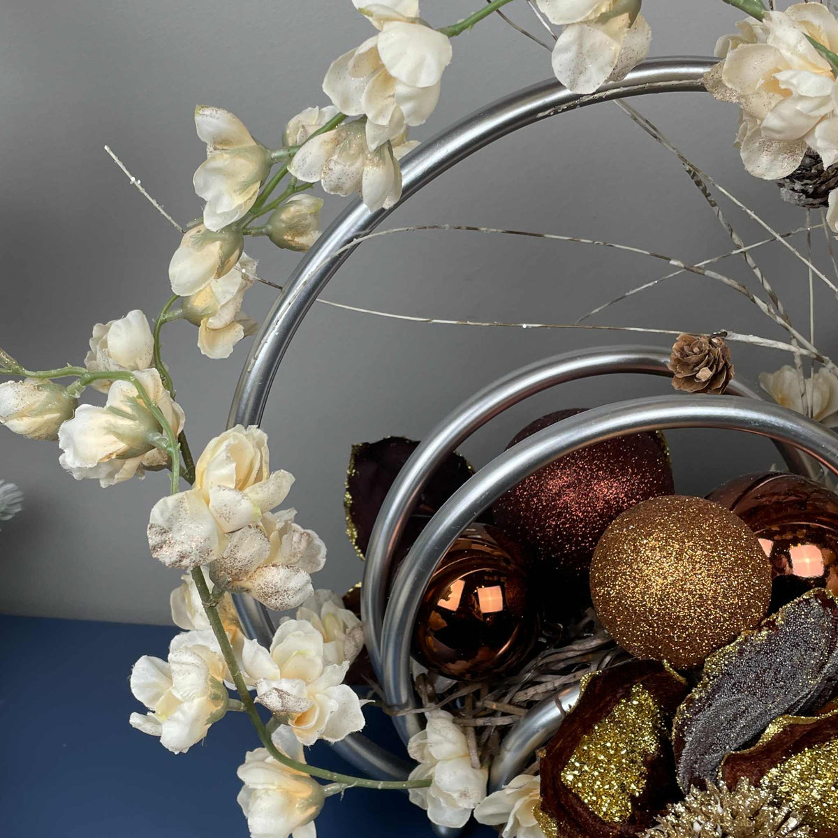 Bronze Magnolia Centerpiece with Cream Flowers & Silver Rings