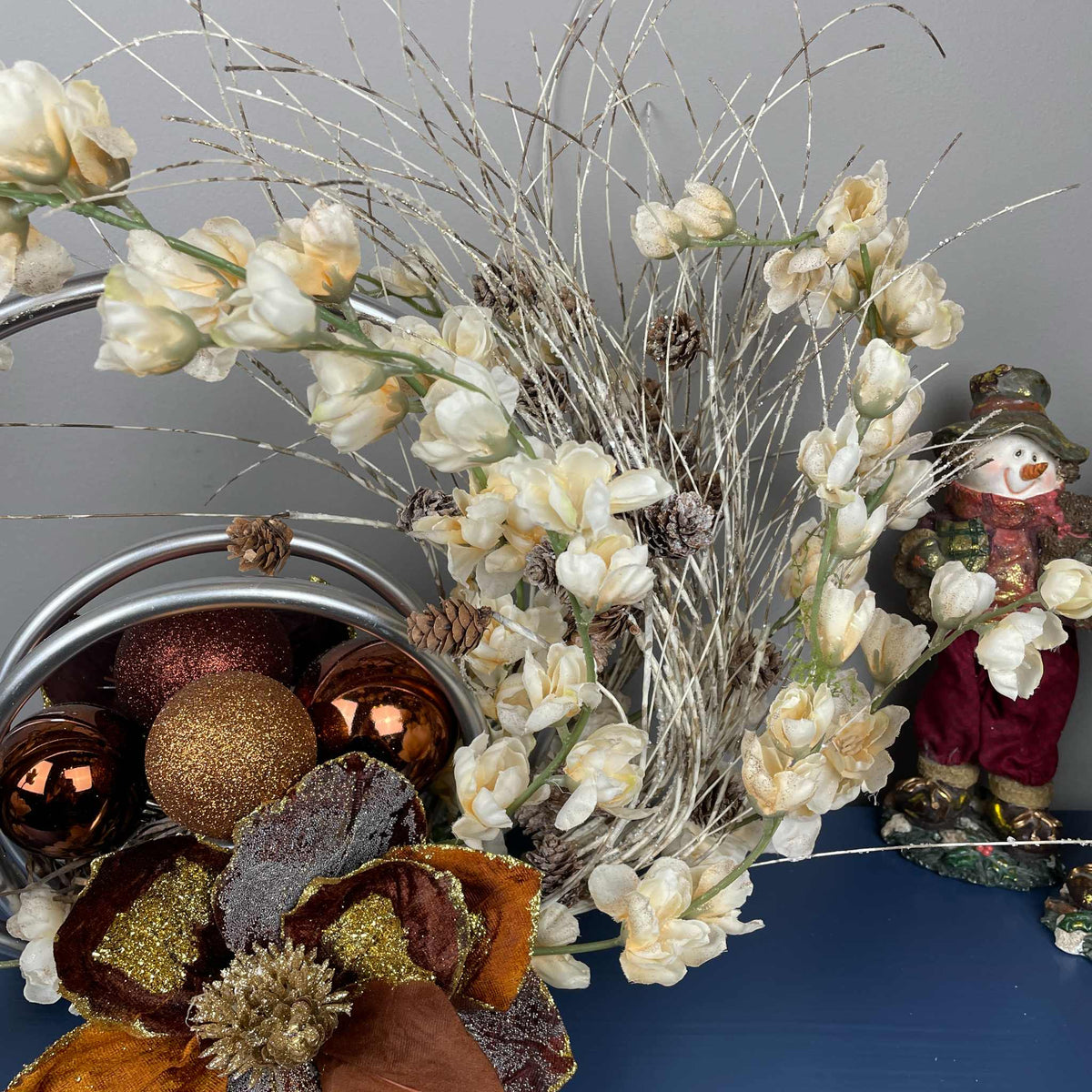 Bronze Magnolia Centerpiece with Cream Flowers & Silver Rings
