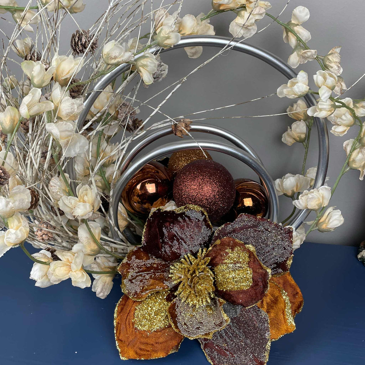 Bronze Magnolia Centerpiece with Cream Flowers & Silver Rings