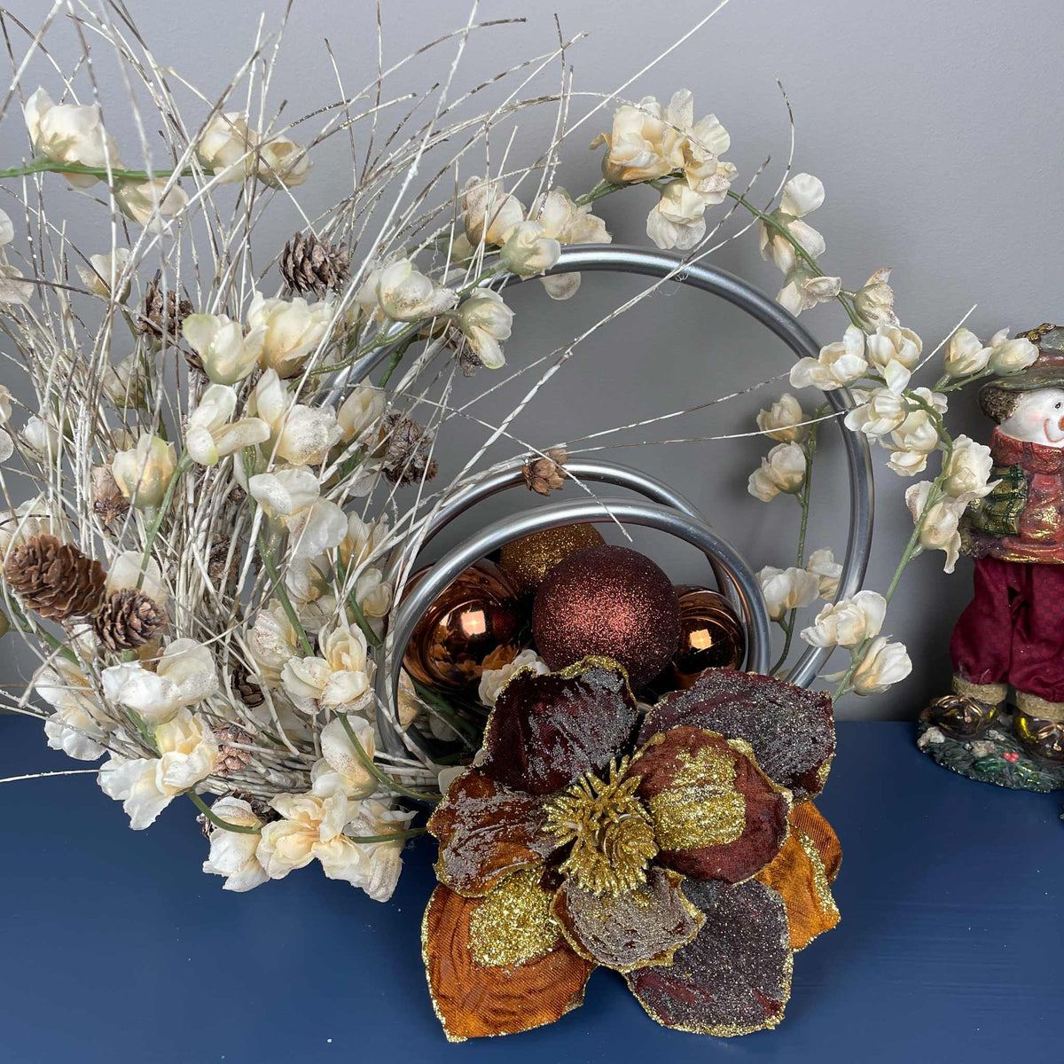 Bronze Magnolia Centerpiece with Cream Flowers & Silver Rings